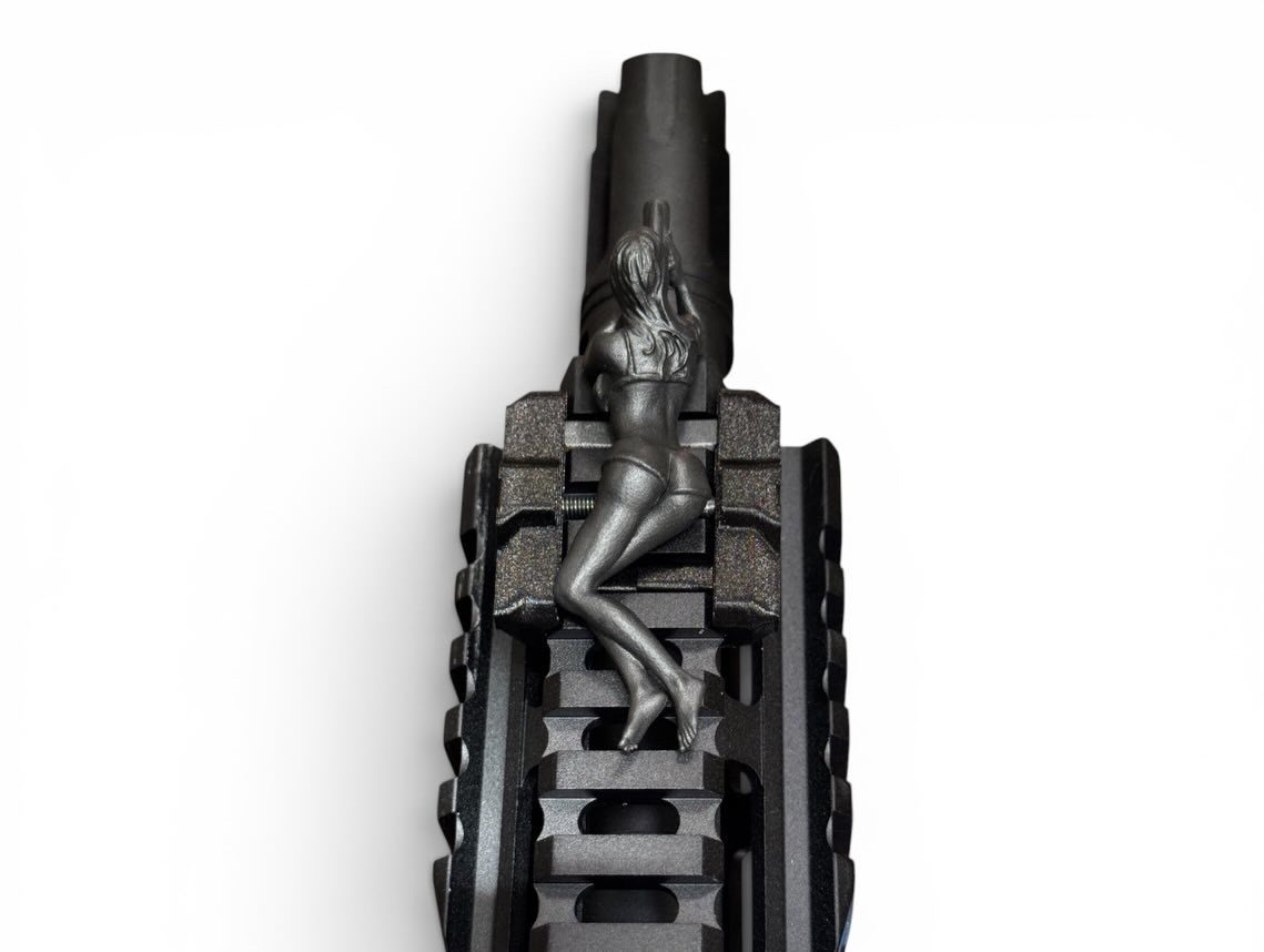Close-up detail of the Spotter G figure showing its hand-finished sculptural carving